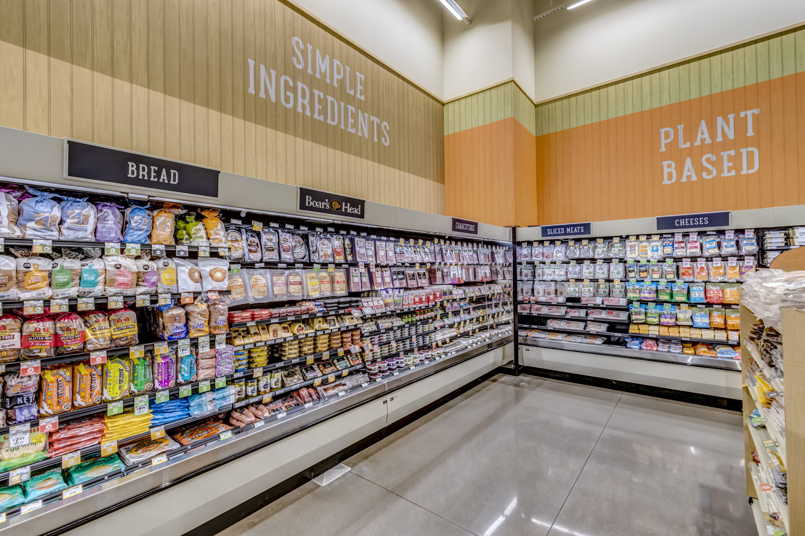 A well lit aisle in Sprouts Farmers Market displaying simple-ingredient and plant-based foods.
